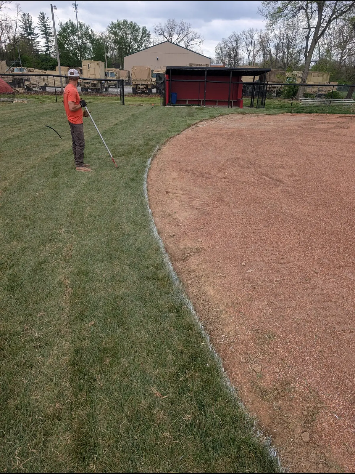 Crew member edging the grass along an infield skin, serving Indianapolis, IN