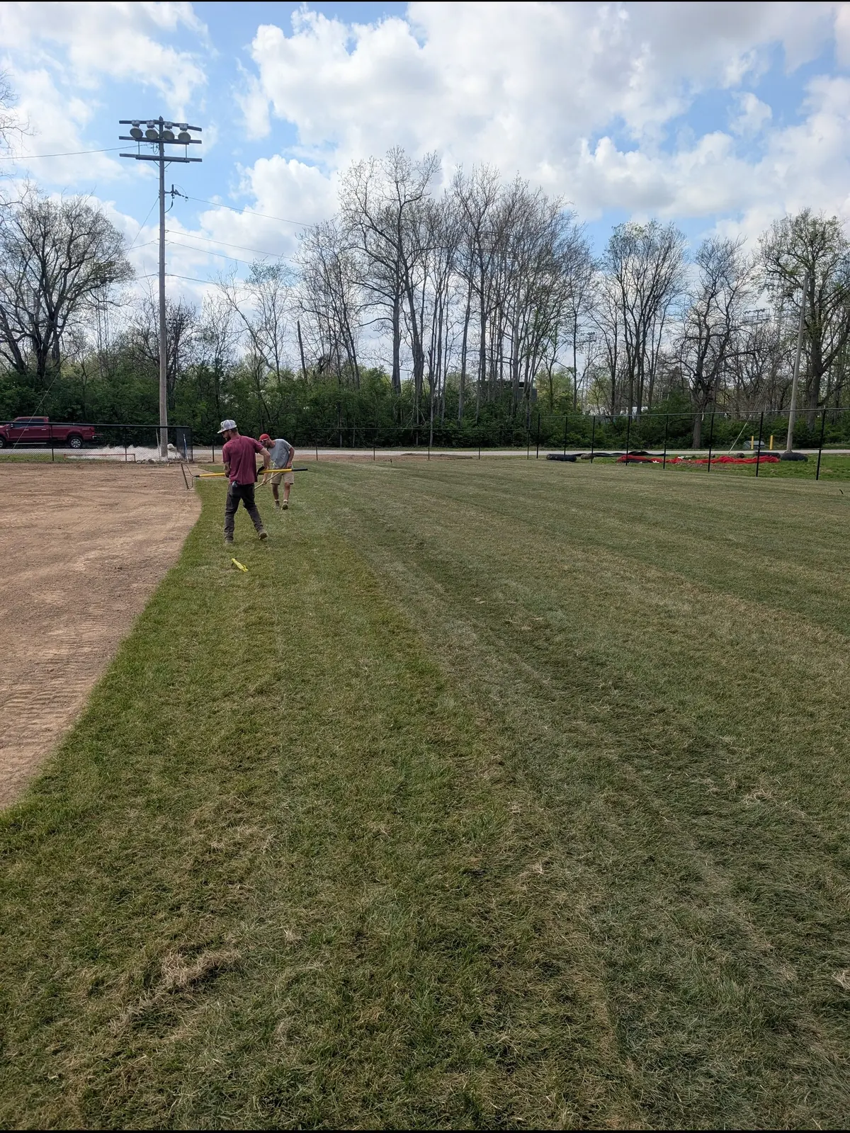 Crew working the transition between infield skin and outfield grass, serving Dayton, OH