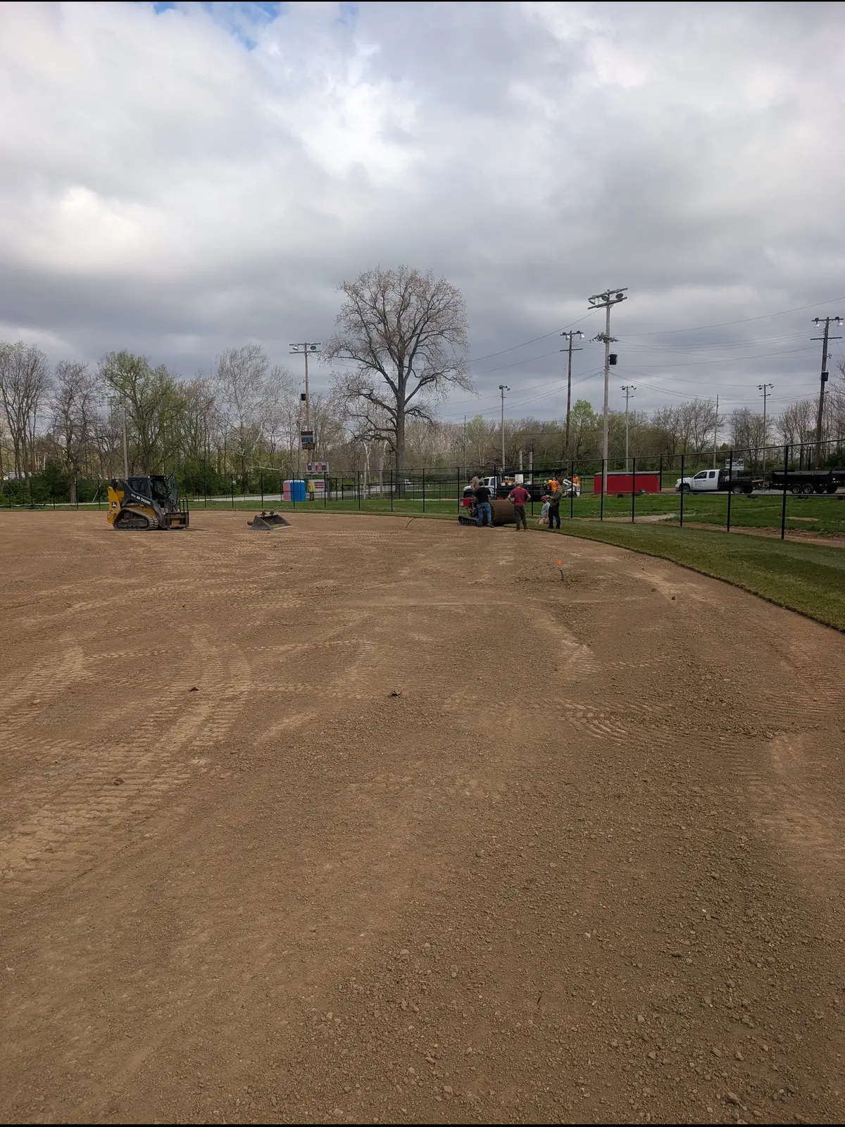Equipment working an infield skin under a cloudy sky, serving Dayton, OH