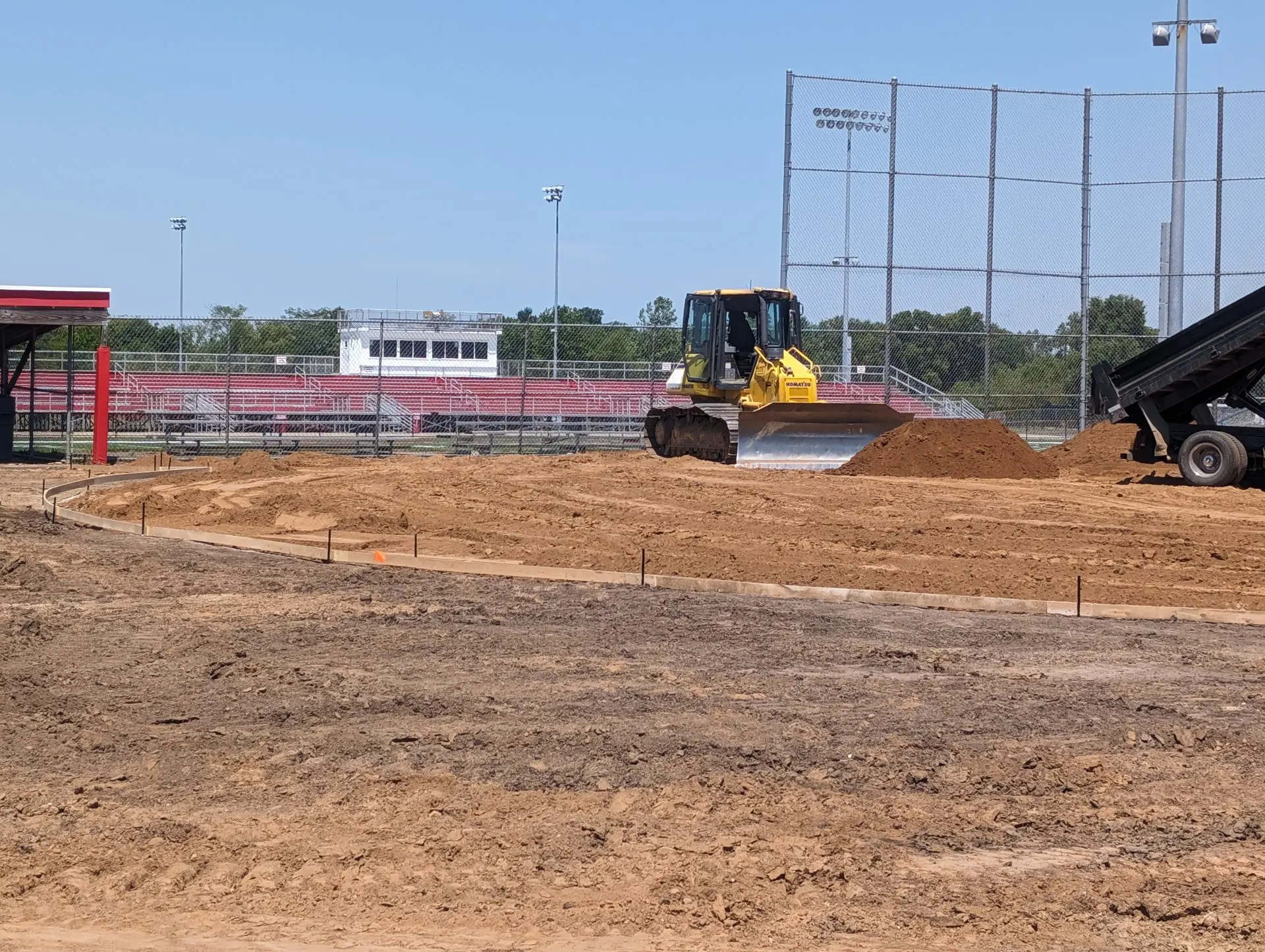 Dozer grading the base for a new baseball infield during field construction