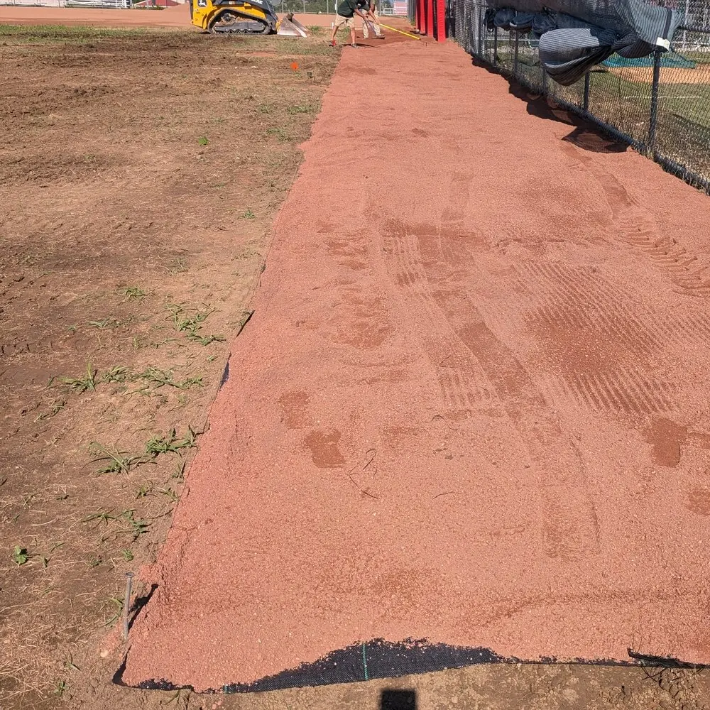 Marco Clay warning track material freshly installed along an outfield fence, serving Dayton, OH