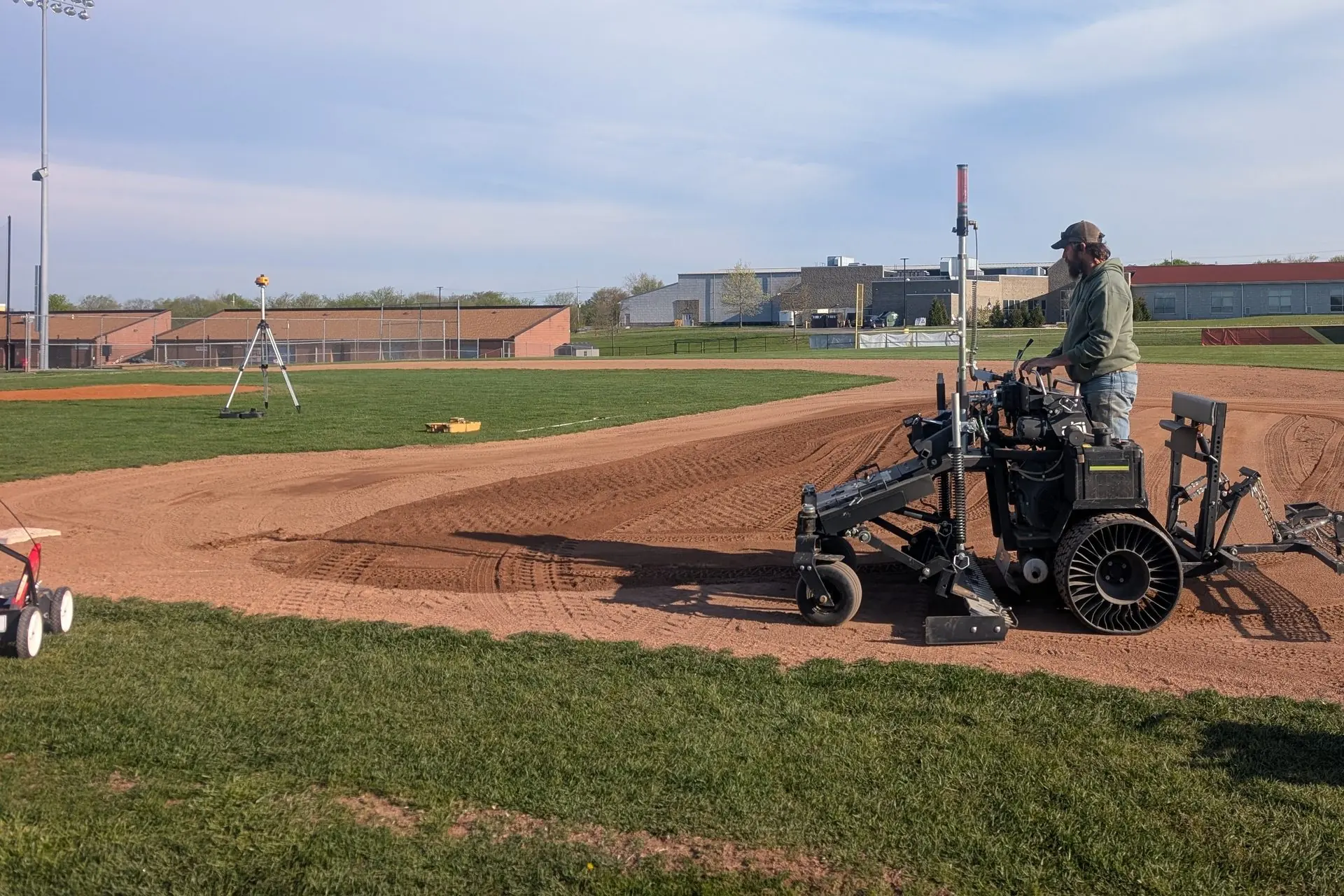 Laser-guided grader leveling a new baseball infield skin, serving Dayton, OH