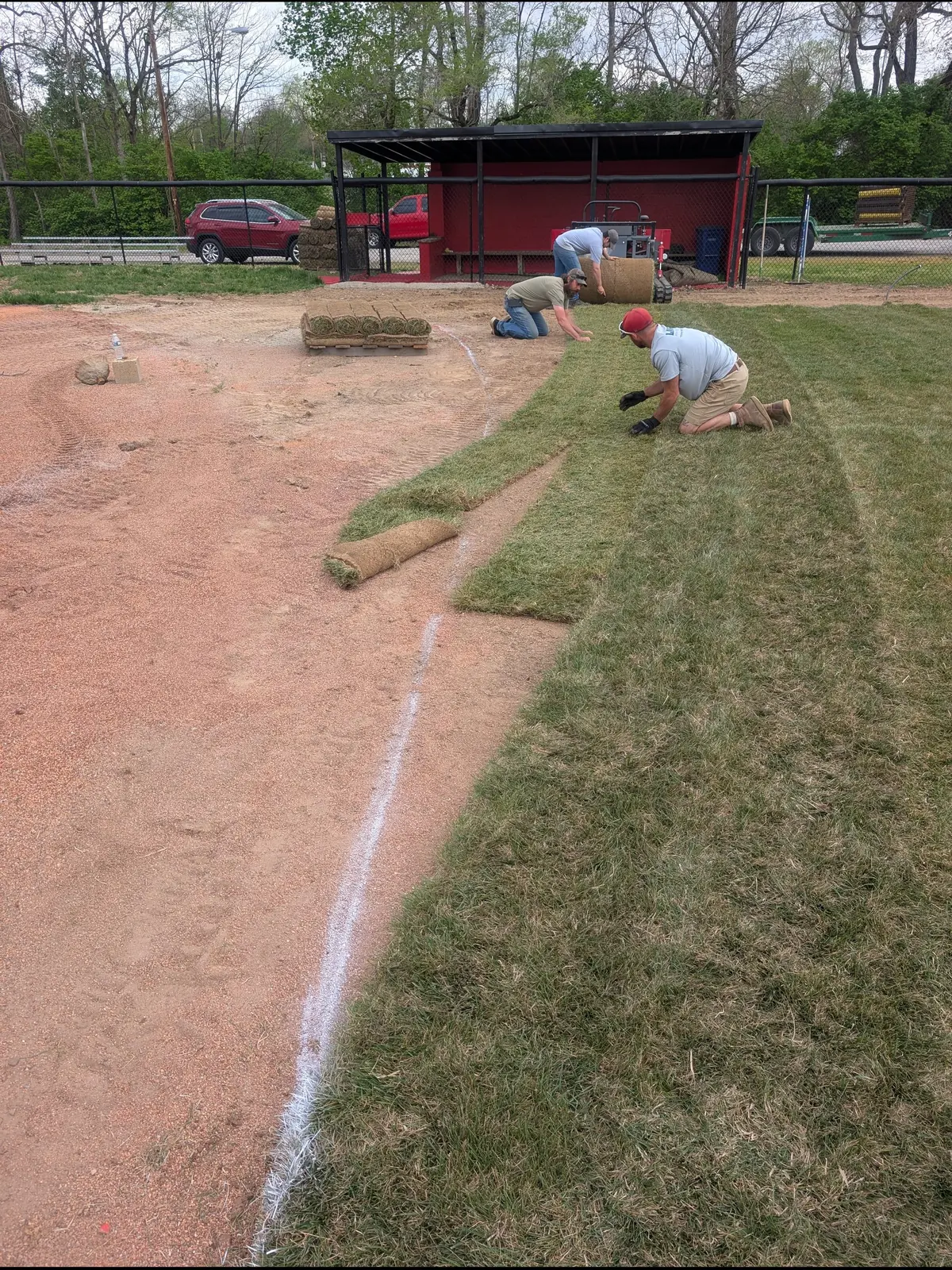 Crew laying sod along a freshly lined infield edge, serving Dayton, OH